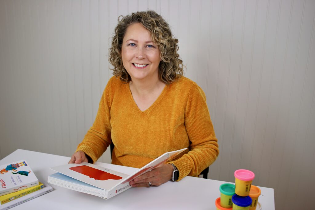 Denise Stratton with a child's book